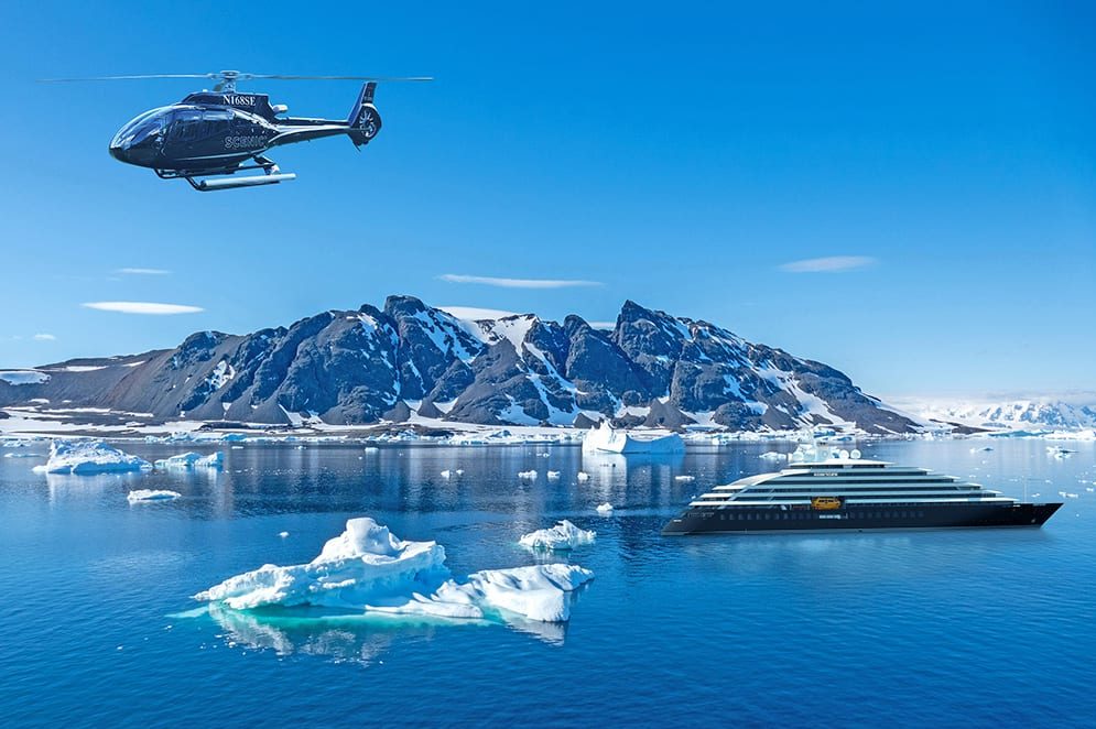 Mountain landscape, Antarctica with the Scenic Eclipse on water and a helicopter